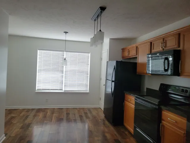 a kitchen with a refrigerator stove and microwave