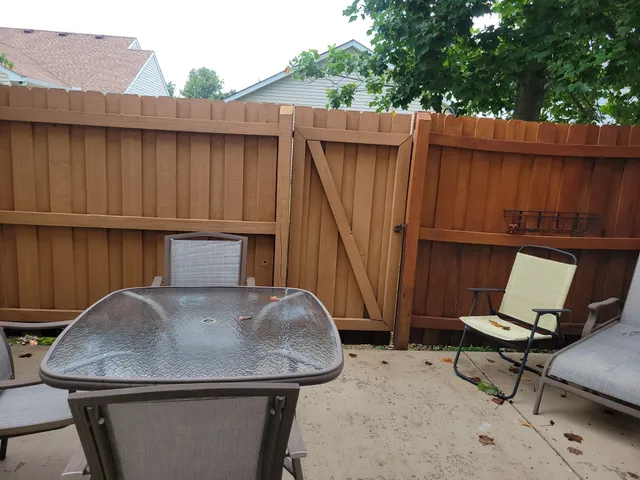a view of backyard with table and chair