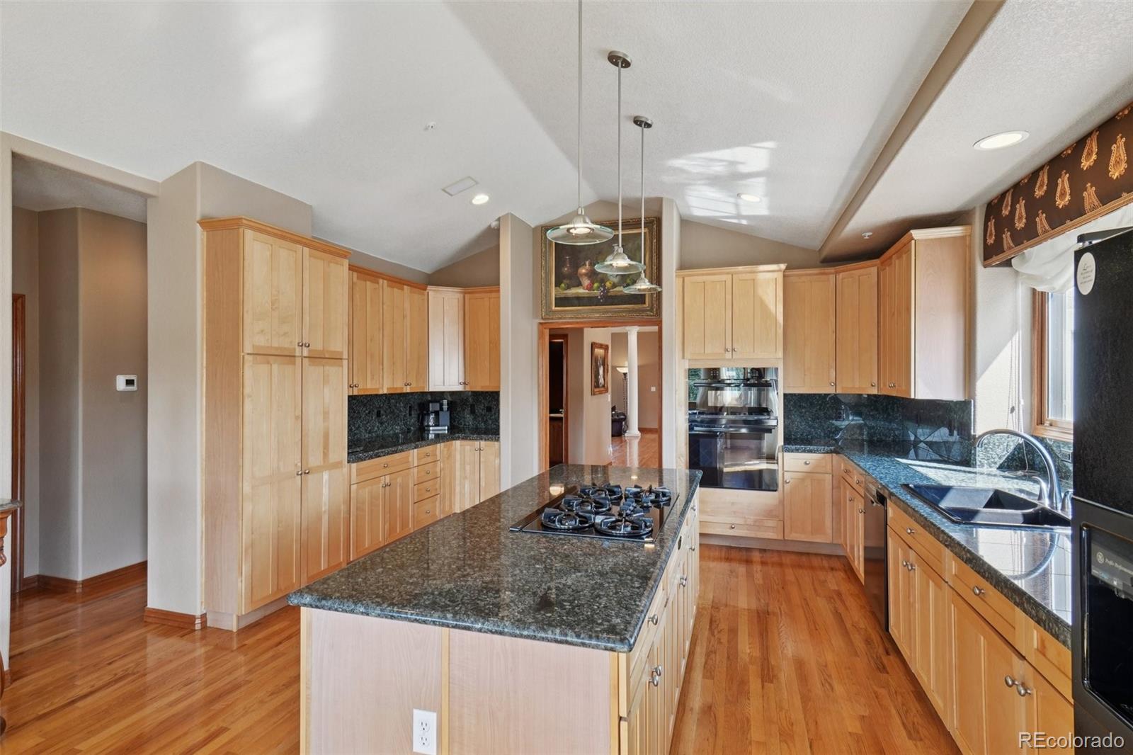 1475 Elk View Road Larkspur, CO 80118 - Photo 13 of 45 a large kitchen with a large window and stainless steel appliances