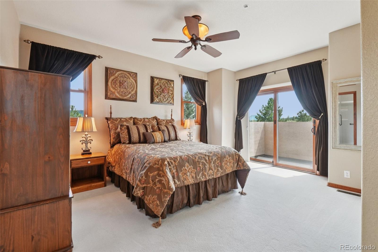 1475 Elk View Road Larkspur, CO 80118 - Photo 20 of 45 a bedroom with a bed and a window