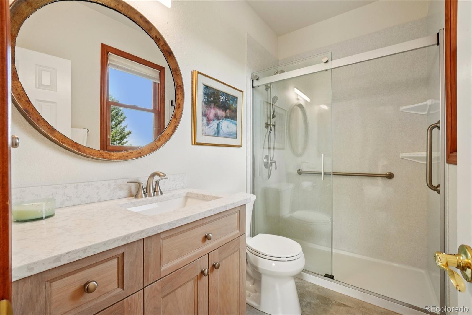 1475 Elk View Road Larkspur, CO 80118 - Photo 21 of 45 a bathroom with a sink a toilet and a mirror