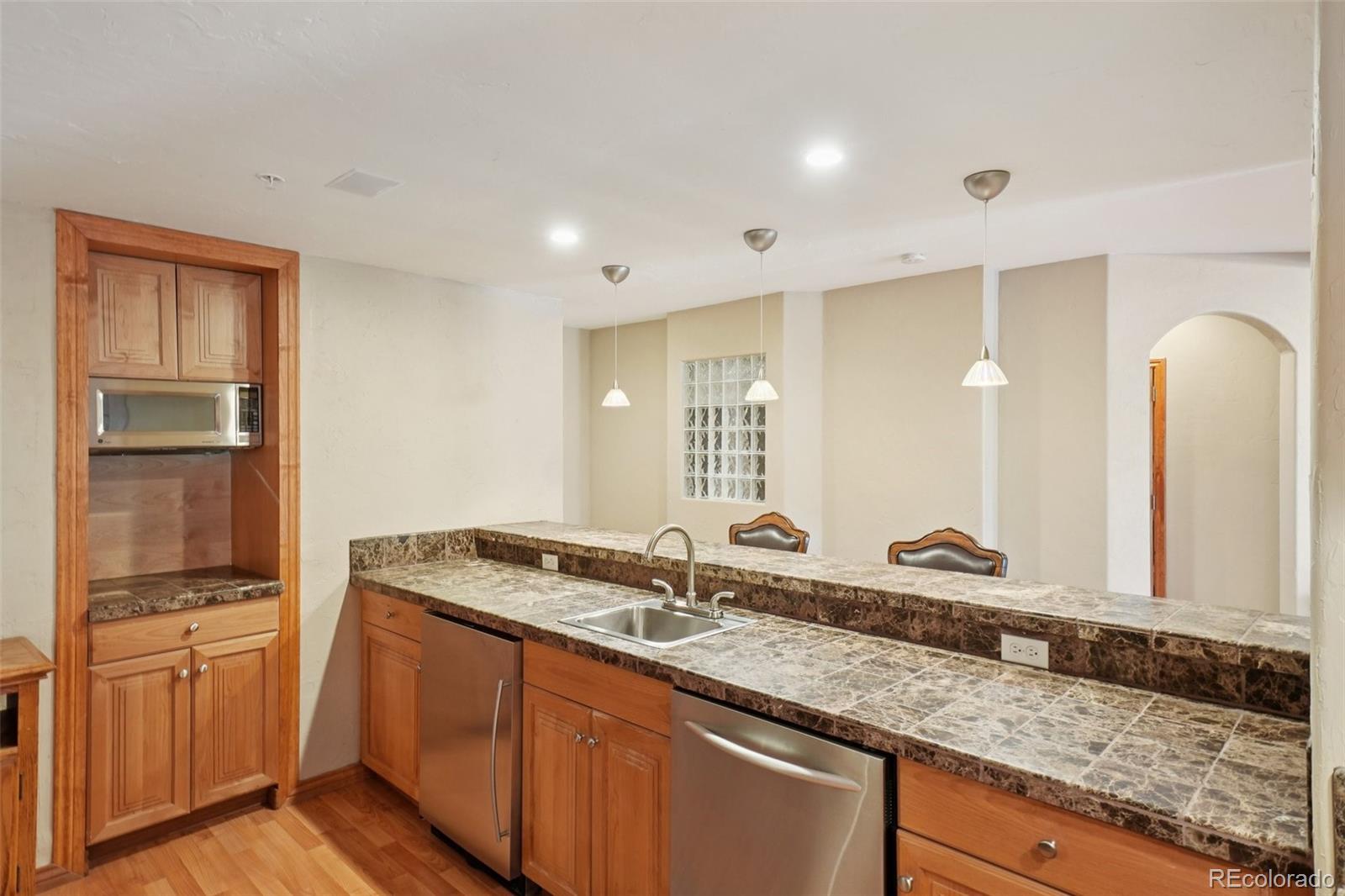 1475 Elk View Road Larkspur, CO 80118 - Photo 27 of 45 a bathroom with sink and mirror