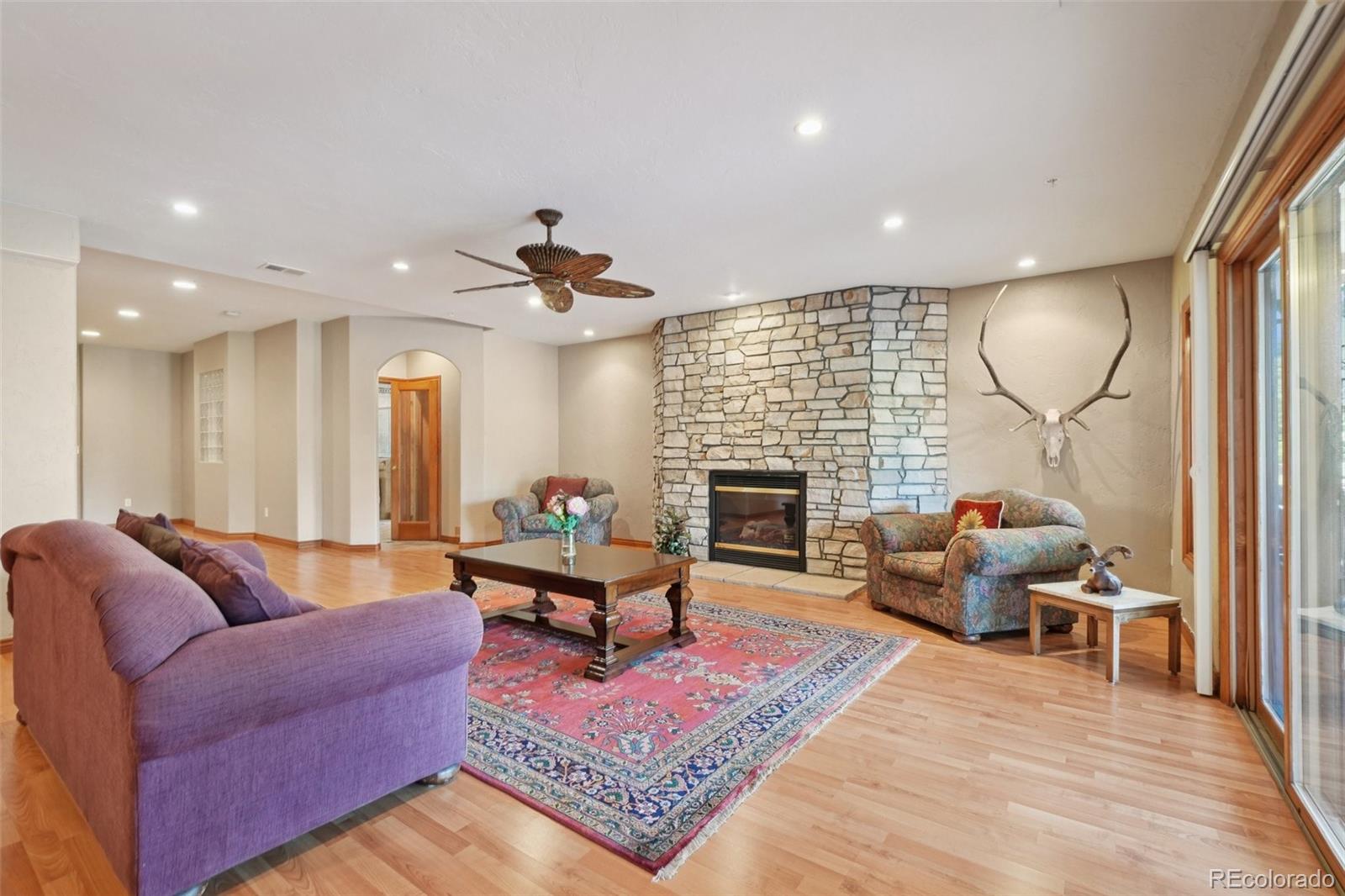 1475 Elk View Road Larkspur, CO 80118 - Photo 28 of 45 a living room with furniture fireplace and rug