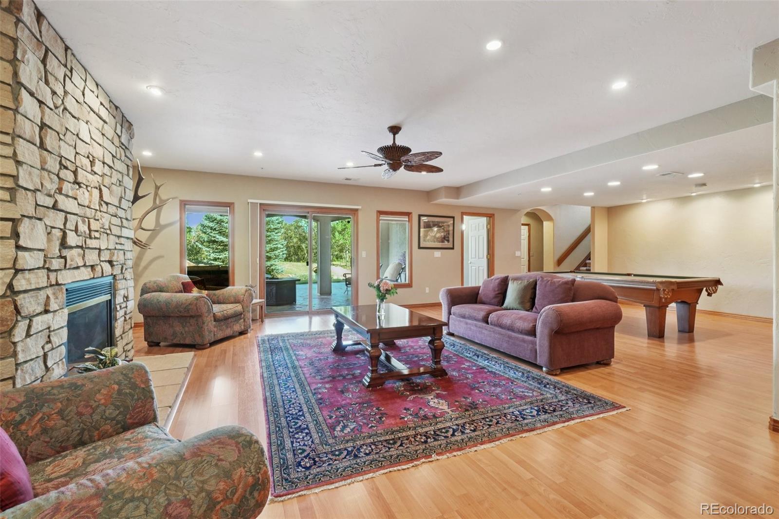 1475 Elk View Road Larkspur, CO 80118 - Photo 29 of 45 a living room with furniture and a large window
