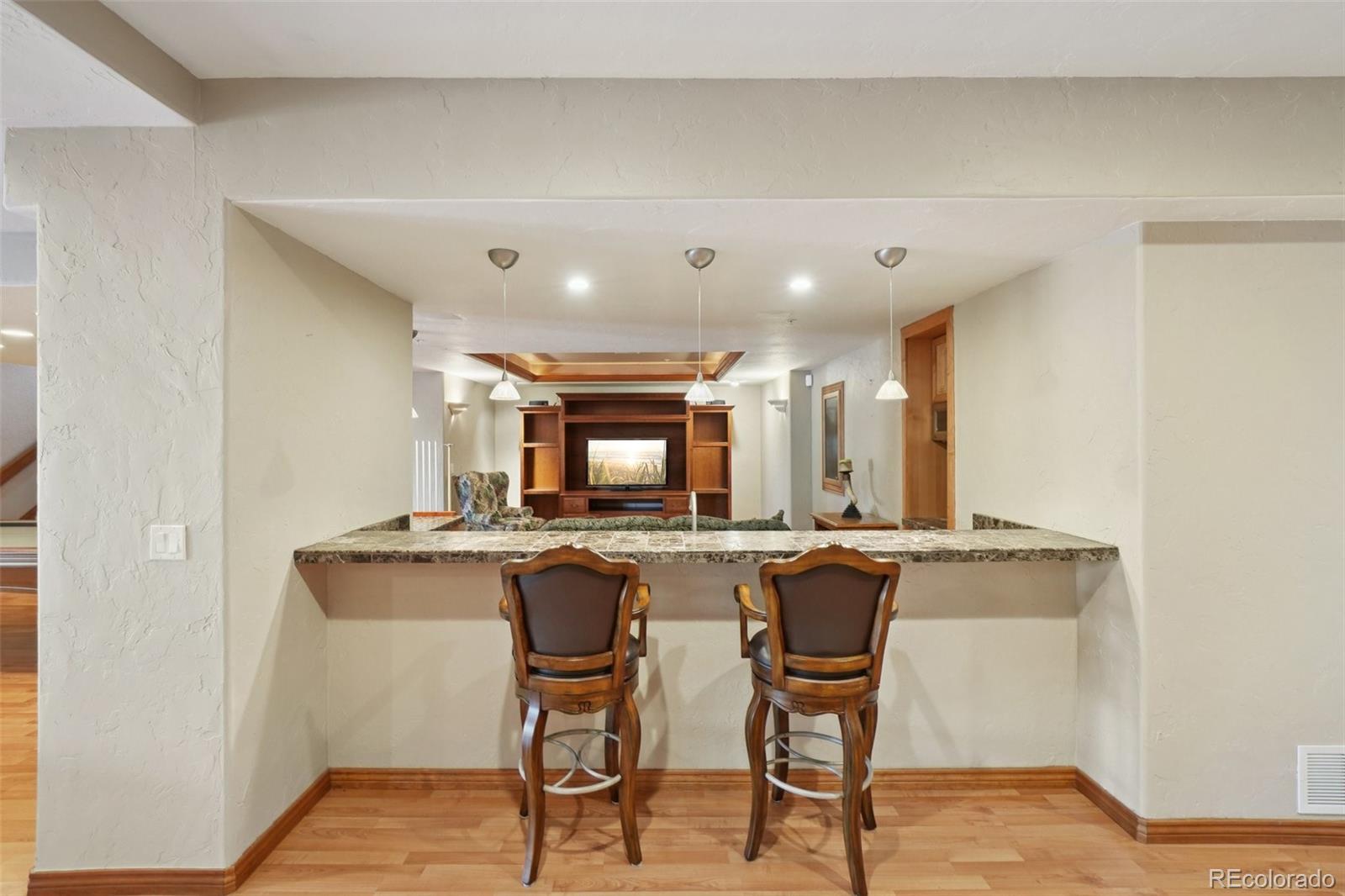 1475 Elk View Road Larkspur, CO 80118 - Photo 30 of 45 a kitchen with a table and chairs in it