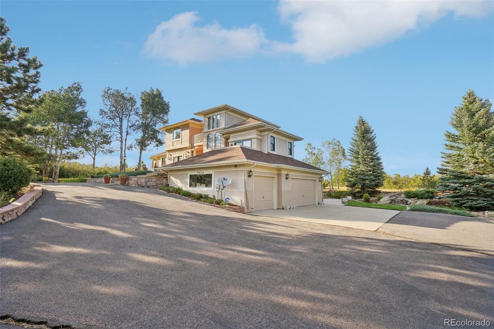 1475 Elk View Road Larkspur, CO 80118 - Photo 3 of 45 a view of a house with a yard