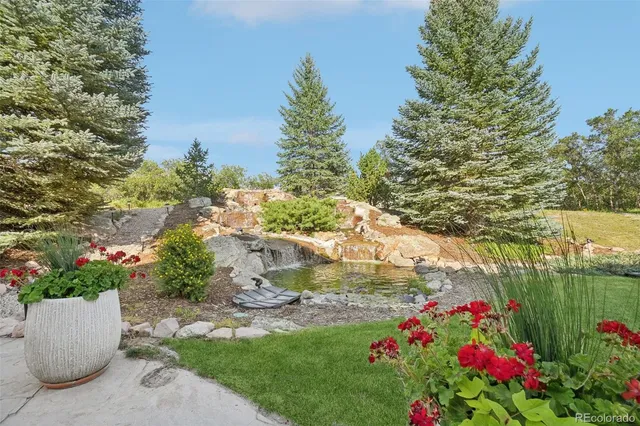 a view of a garden with flowers and trees
