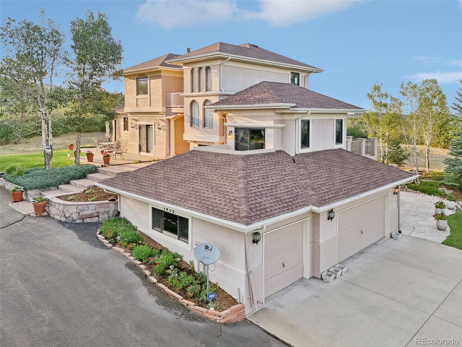 1475 Elk View Road Larkspur, CO 80118 - Photo 40 of 45 a aerial view of a house with a garden and pathway