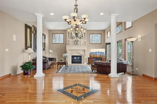 a living room with fireplace furniture and a chandelier
