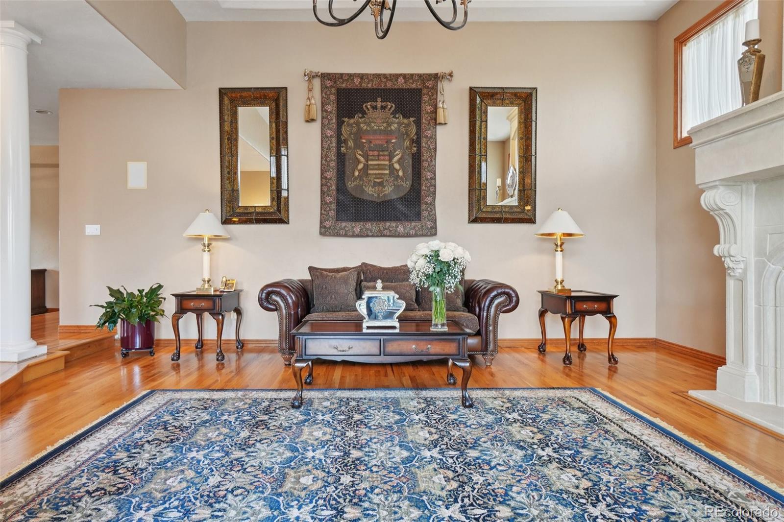1475 Elk View Road Larkspur, CO 80118 - Photo 10 of 45 a living room with furniture and a rug