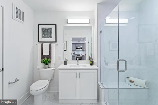a bathroom with a shower sink and mirror