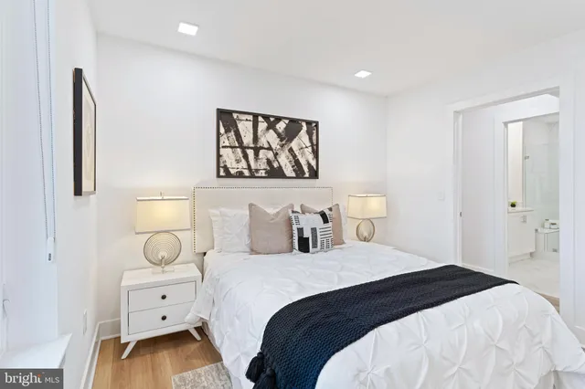 a bedroom with a bed and painting on the wall