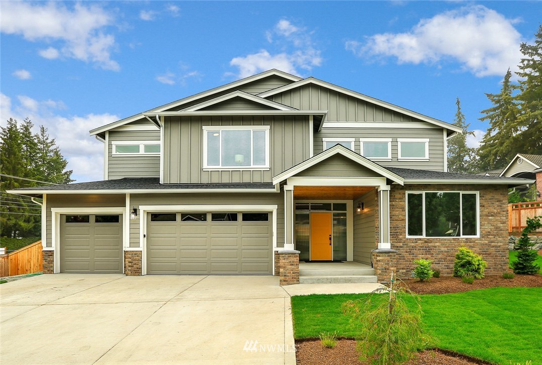 1430 236th Street Southeast Bothell, WA 98021 - Photo 1 of 38 a front view of a house with a yard and garage