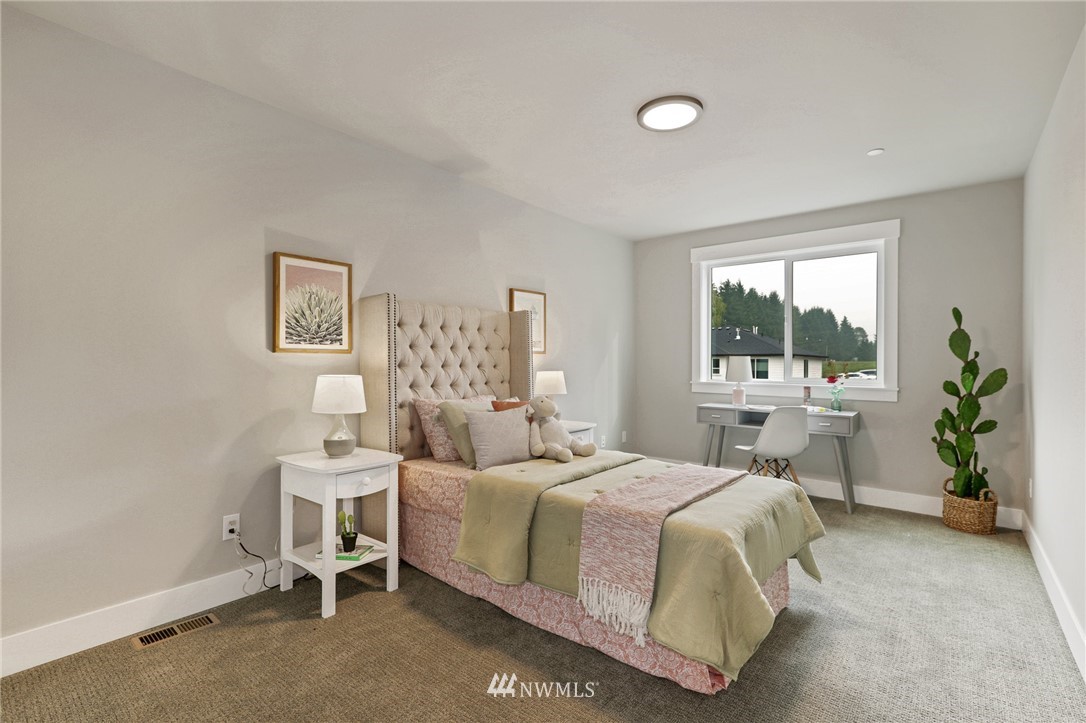 1430 236th Street Southeast Bothell, WA 98021 - Photo 25 of 38 a bedroom with a bed and a table