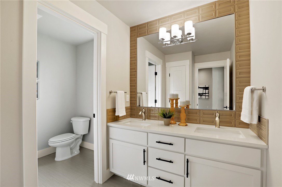 1430 236th Street Southeast Bothell, WA 98021 - Photo 27 of 38 a bathroom with a double vanity sink mirror and toilet