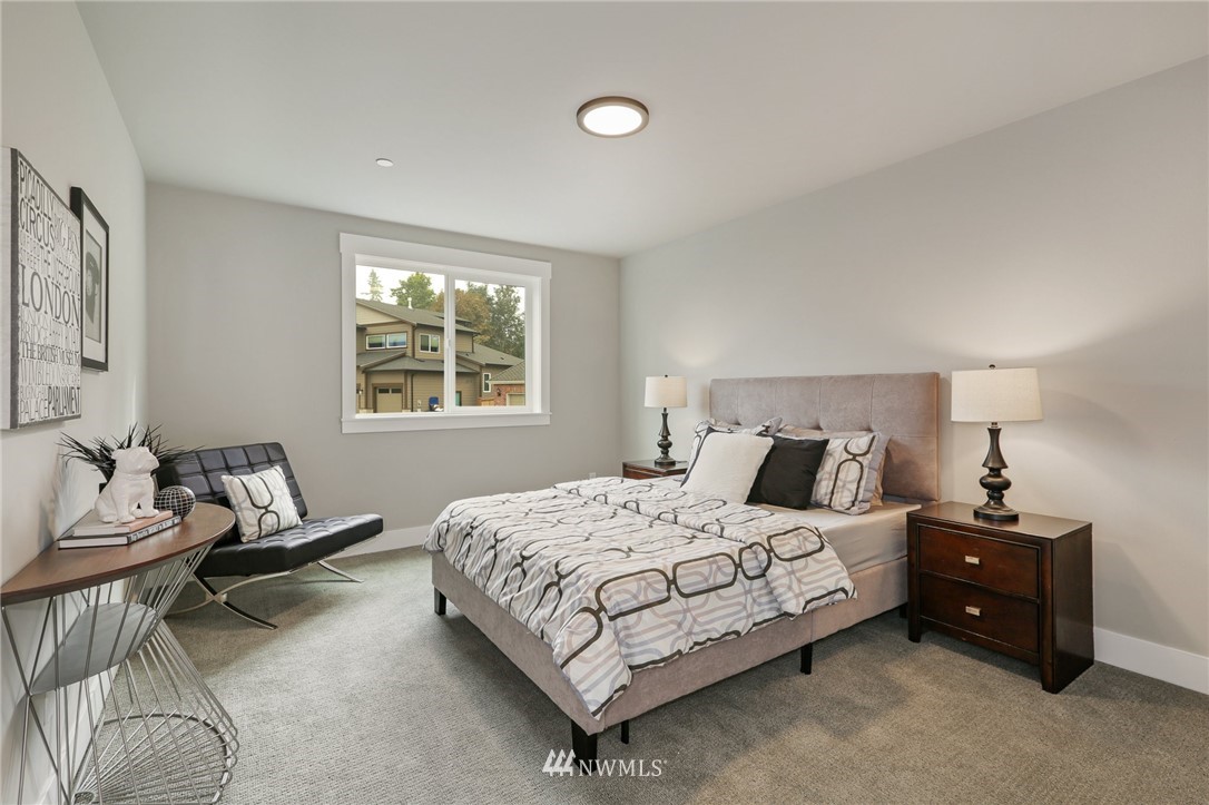 1430 236th Street Southeast Bothell, WA 98021 - Photo 28 of 38 a bedroom with a bed and a couch