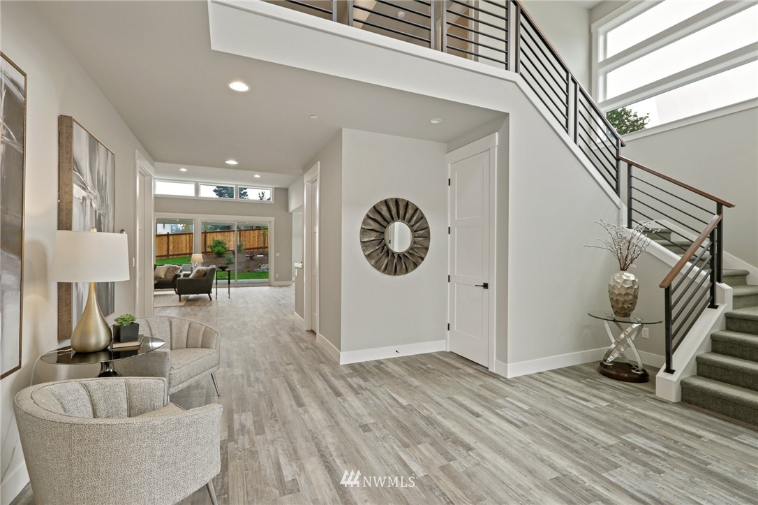 1430 236th Street Southeast Bothell, WA 98021 - Photo 4 of 38 a view of living room kitchen and a wooden floor