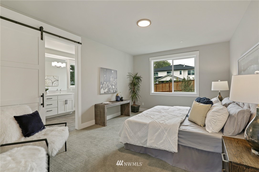 1430 236th Street Southeast Bothell, WA 98021 - Photo 31 of 38 a bedroom with a bed and wooden floor