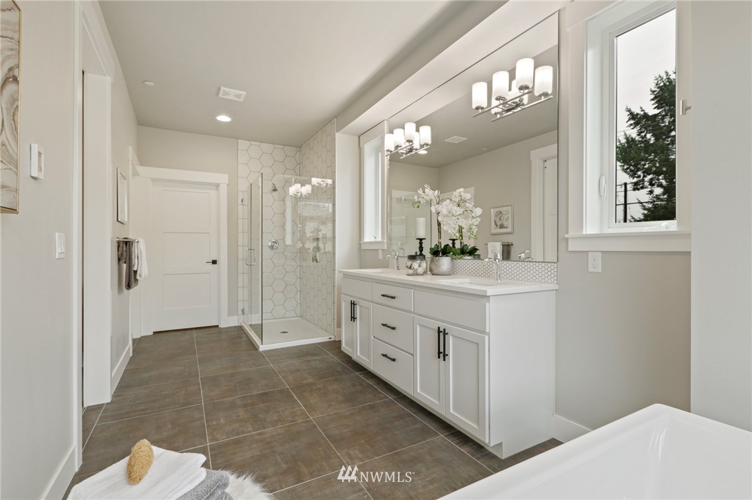 1430 236th Street Southeast Bothell, WA 98021 - Photo 32 of 38 a bathroom with a double vanity sink and a mirror