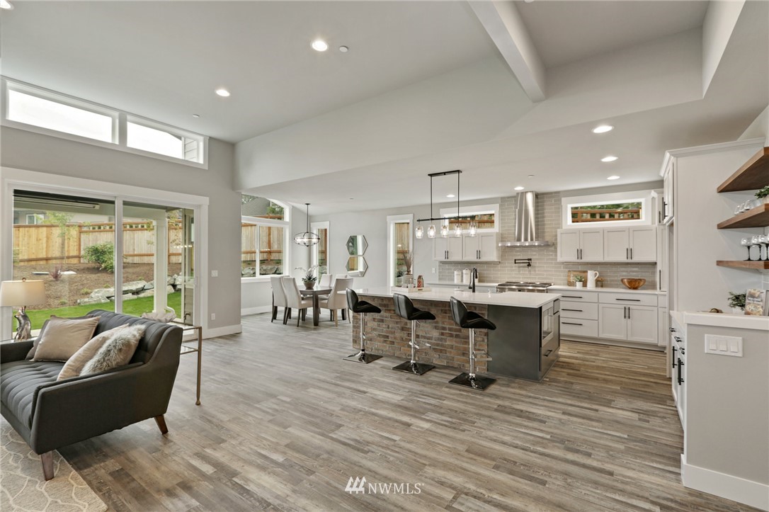 1430 236th Street Southeast Bothell, WA 98021 - Photo 5 of 38 a living room with stainless steel appliances kitchen island granite countertop furniture and a large window