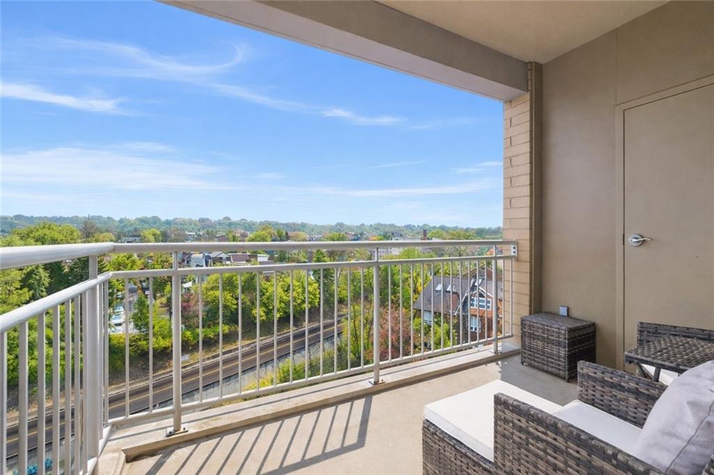 5570 Centre Avenue, Unit 400 Pittsburgh, PA 15232 - Photo 12 of 28 a view of a balcony with couches and wooden floor
