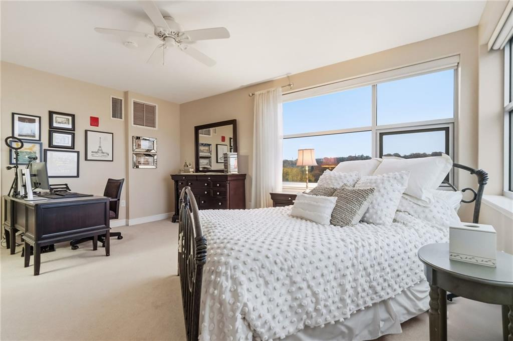 5570 Centre Avenue, Unit 400 Pittsburgh, PA 15232 - Photo 15 of 28 a bedroom with a bed large window and a table