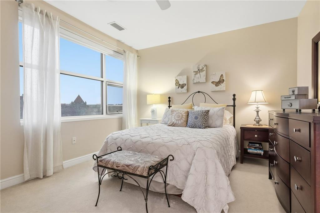 5570 Centre Avenue, Unit 400 Pittsburgh, PA 15232 - Photo 19 of 28 a bedroom with a bed and window with chair