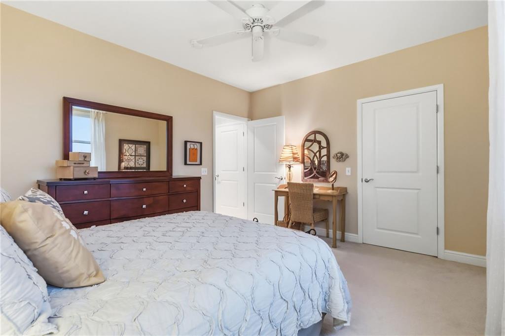 5570 Centre Avenue, Unit 400 Pittsburgh, PA 15232 - Photo 21 of 28 a bedroom with a bed and a chandelier