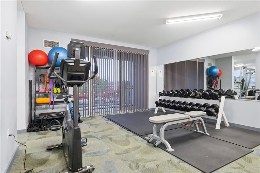 5570 Centre Avenue, Unit 400 Pittsburgh, PA 15232 - Photo 26 of 28 a living room with furniture a air conditioner and a window