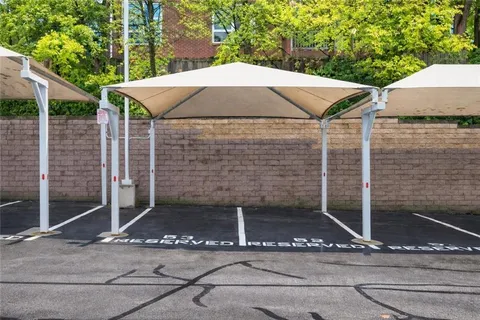 a patio with table and chairs and potted plants