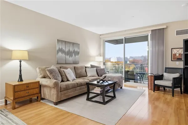 a living room with furniture and a lamp