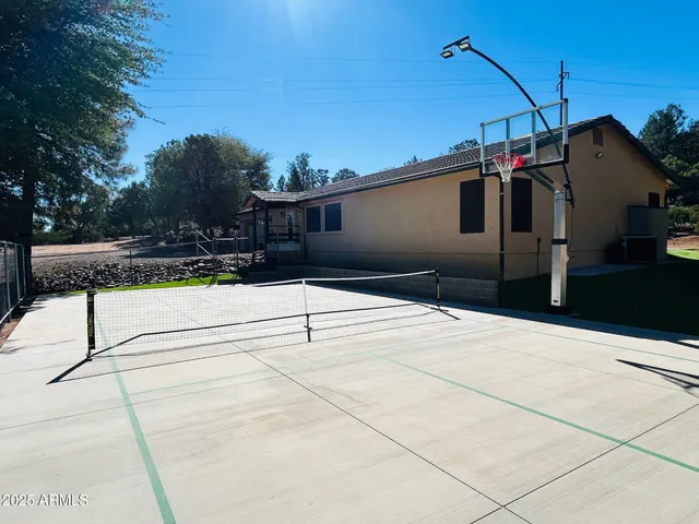 a view of a house with a wooden fence