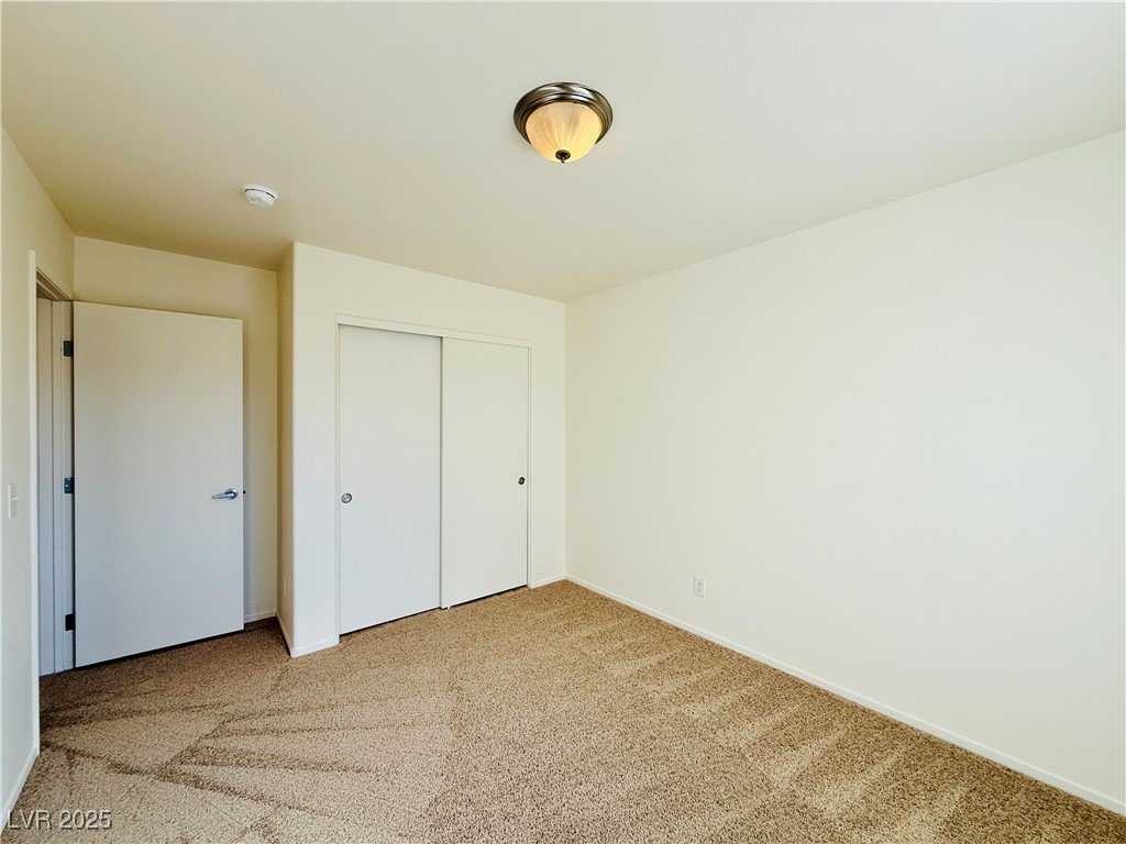 9342 Winebrook Avenue Las Vegas, NV 89148 - Photo 24 of 32 Unfurnished bedroom with light carpet and a closet