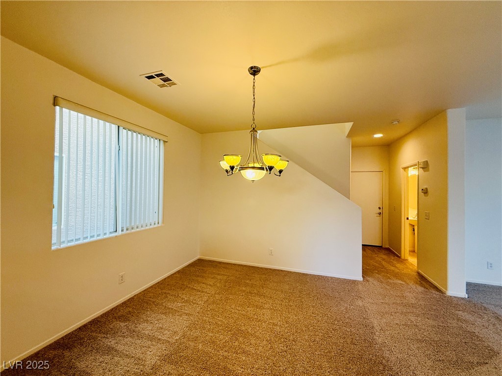 9342 Winebrook Avenue Las Vegas, NV 89148 - Photo 6 of 32 Carpeted empty room featuring a chandelier and recessed lighting