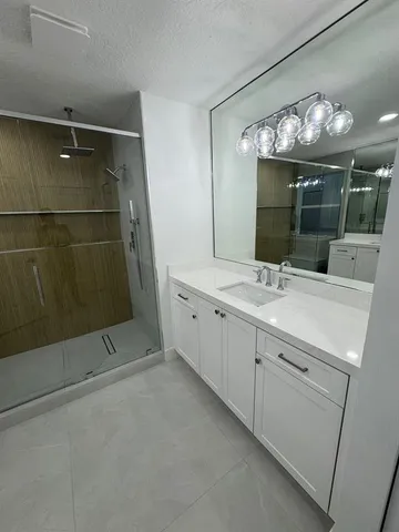 a bathroom with a mirror and a shower