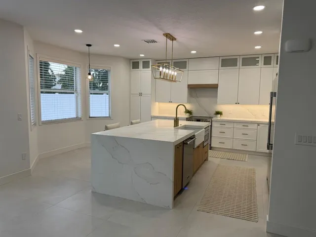 a kitchen with a sink stove and cabinets