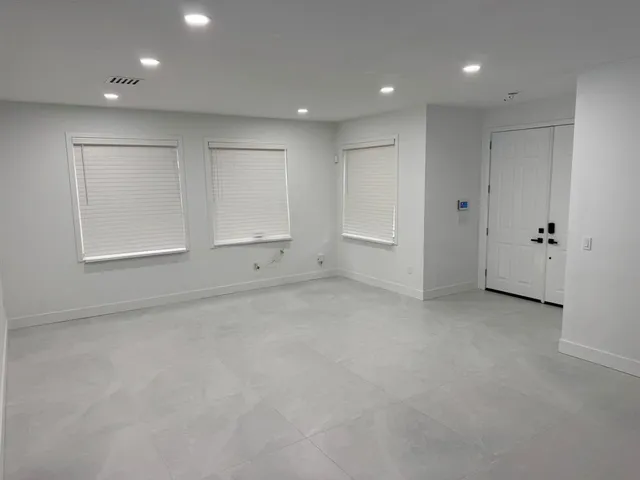 an empty room with cabinet and closet