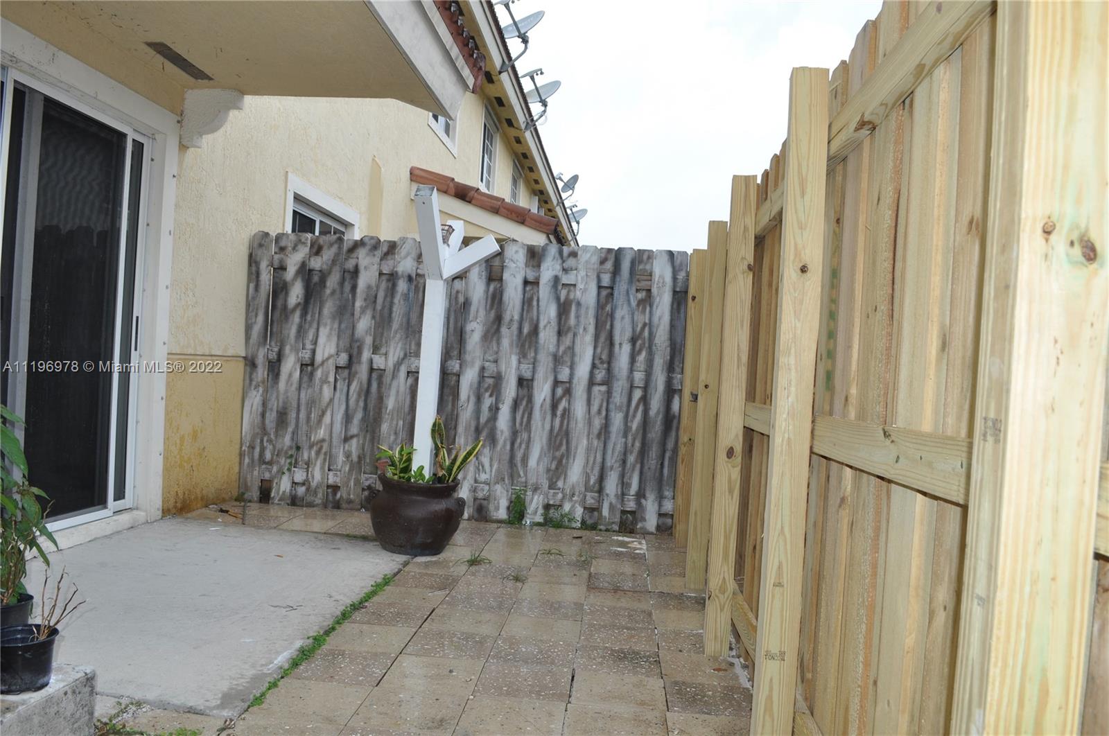 14086 Southwest 260th Street, Unit 106 Homestead, FL 33032 - Photo 11 of 26 a view of a buildings with backyard