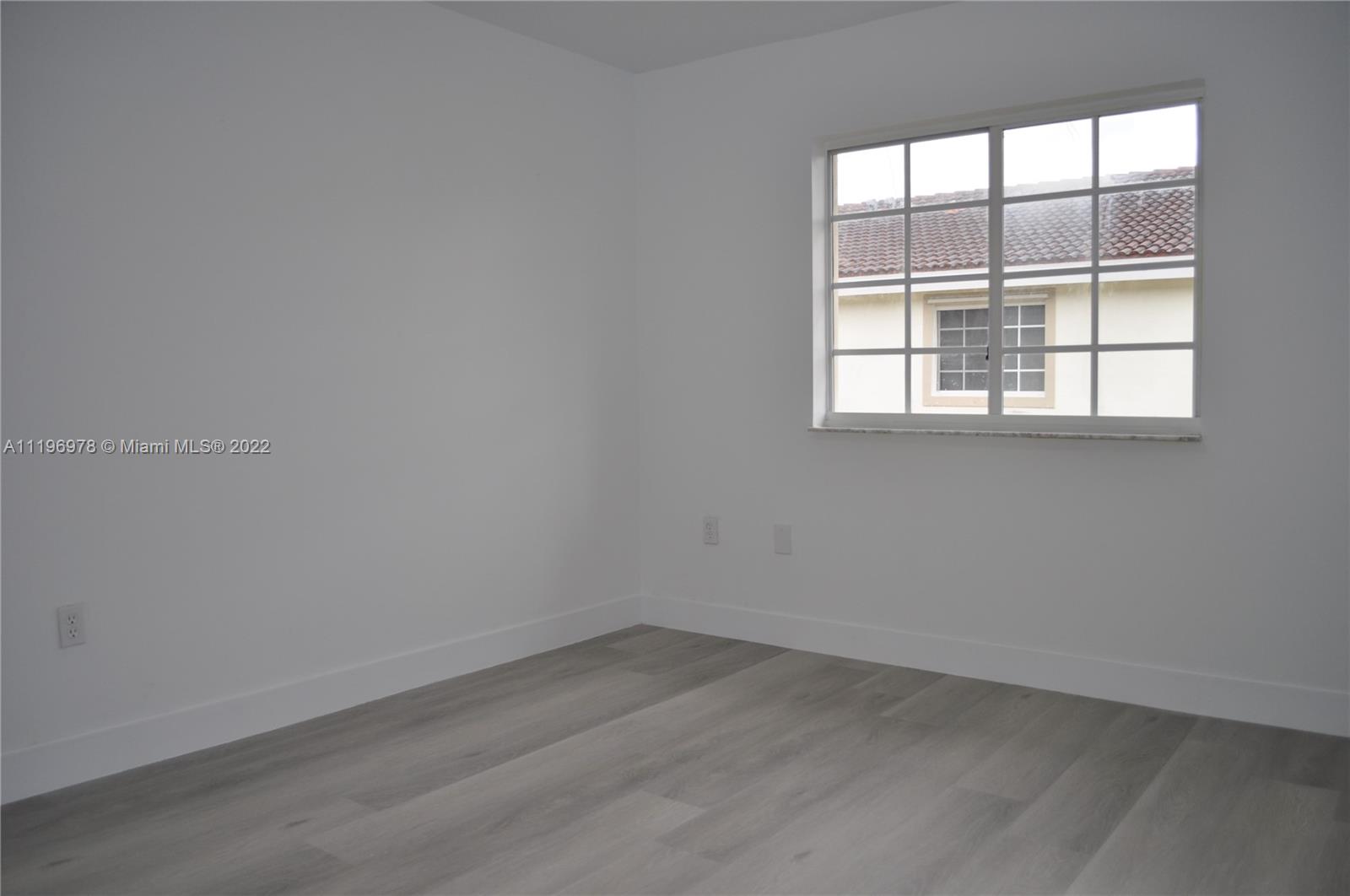 14086 Southwest 260th Street, Unit 106 Homestead, FL 33032 - Photo 16 of 26 an empty room with a window
