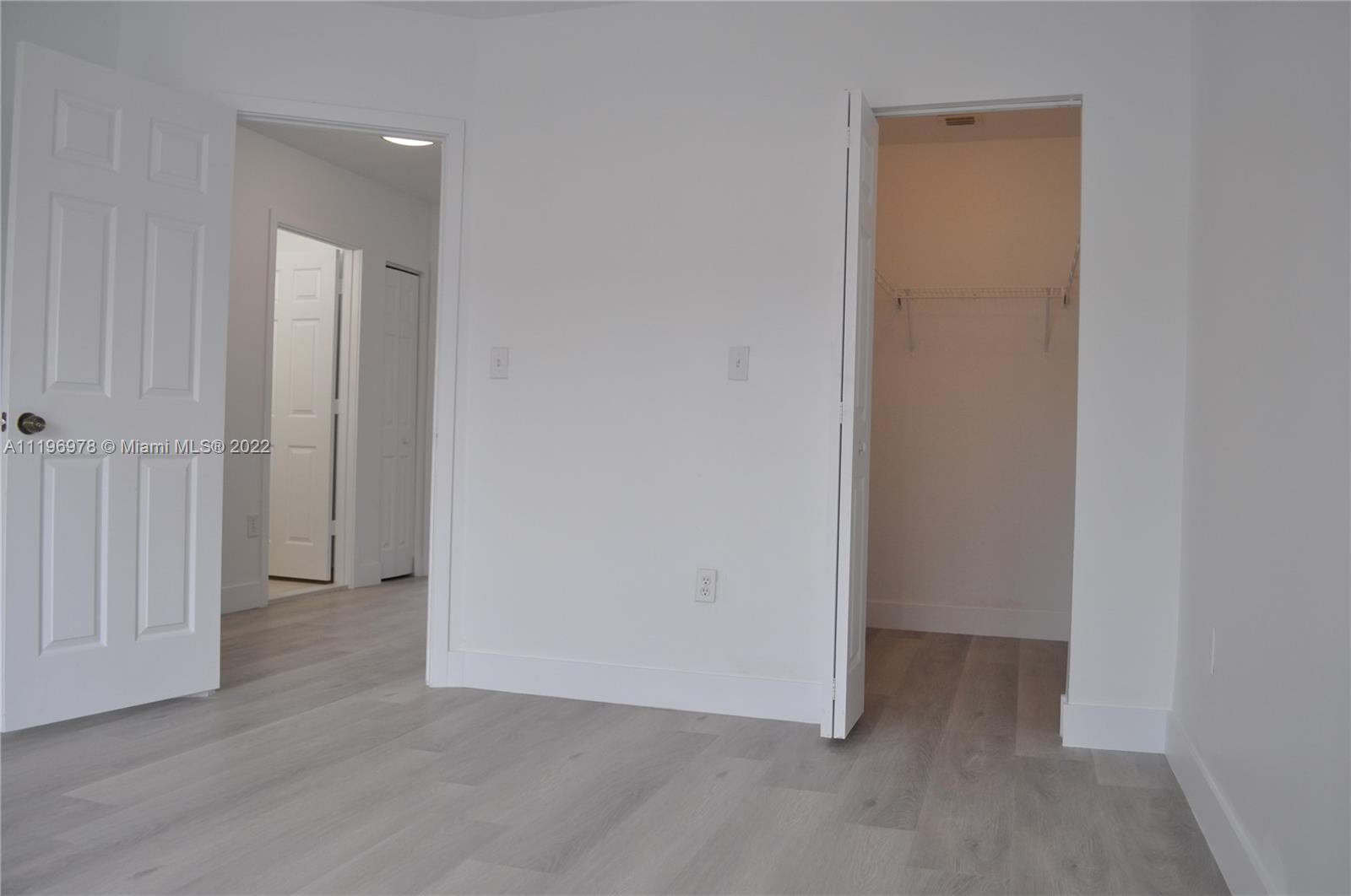 14086 Southwest 260th Street, Unit 106 Homestead, FL 33032 - Photo 23 of 26 an empty room with closet area