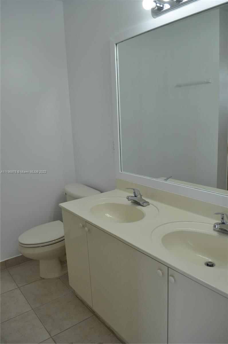14086 Southwest 260th Street, Unit 106 Homestead, FL 33032 - Photo 25 of 26 a bathroom with a sink and a toilet