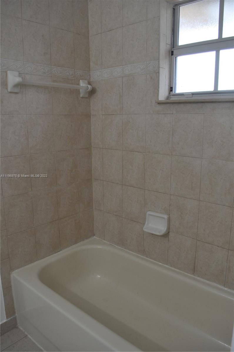 14086 Southwest 260th Street, Unit 106 Homestead, FL 33032 - Photo 26 of 26 a bathroom with a bathtub