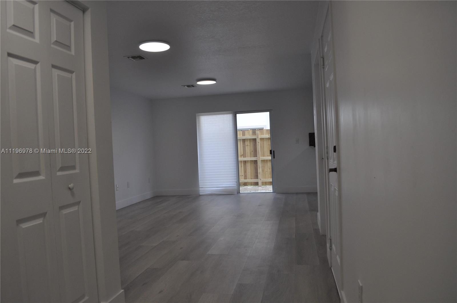 14086 Southwest 260th Street, Unit 106 Homestead, FL 33032 - Photo 3 of 26 a view of entryway with wooden floor