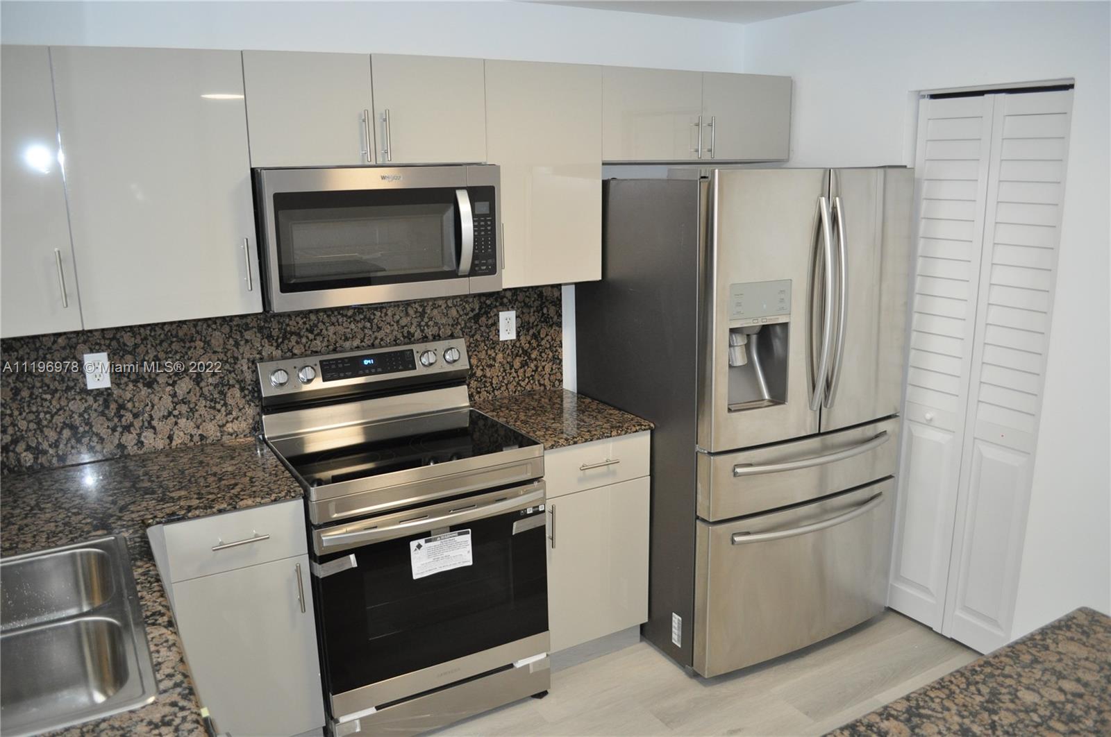 14086 Southwest 260th Street, Unit 106 Homestead, FL 33032 - Photo 10 of 26 a kitchen with appliances and cabinets