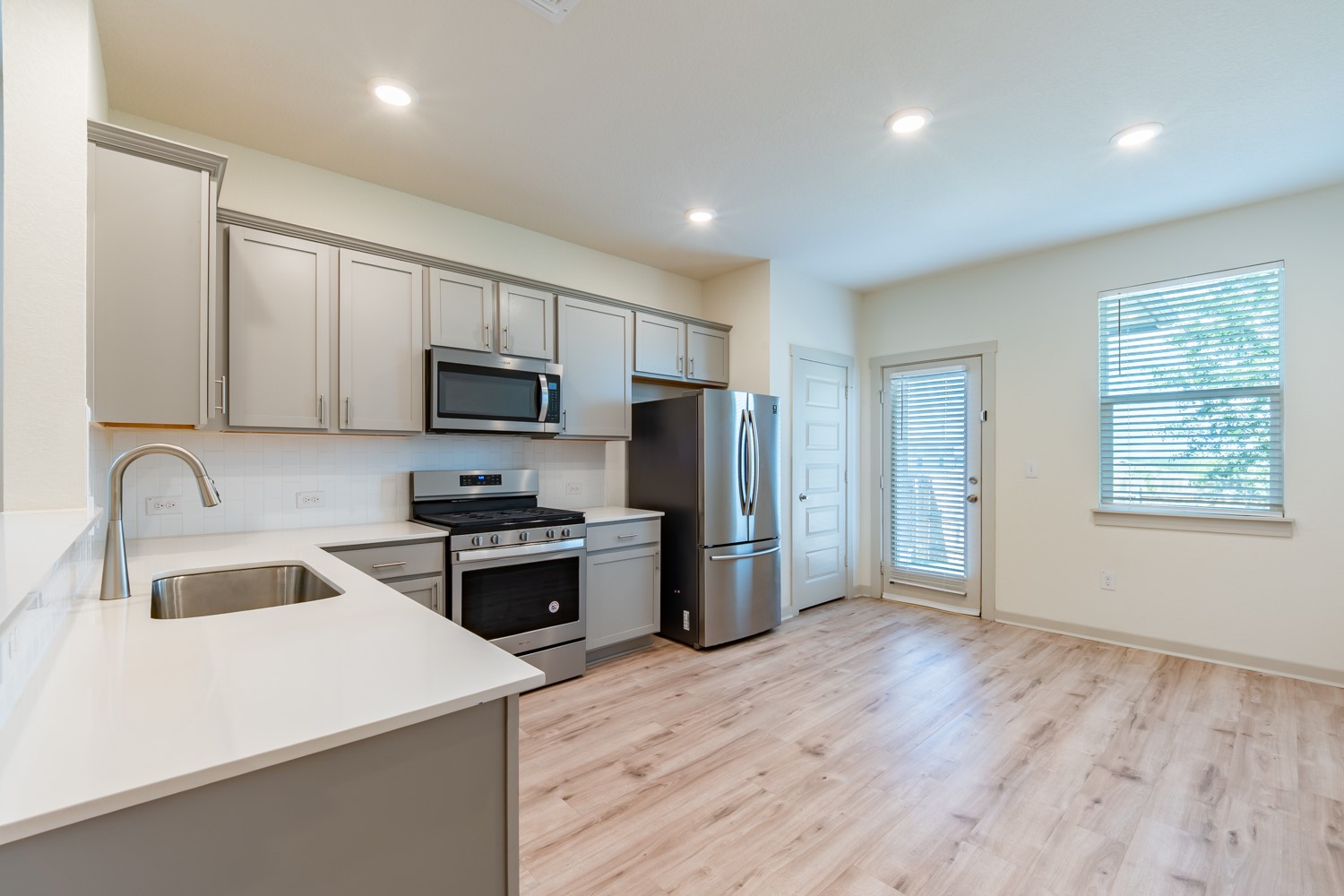 10801 Meris Lane Austin, TX 78754 - Photo 6 of 18 A well-equipped culinary space featuring sleek stainless steel appliances and abundant natural light.