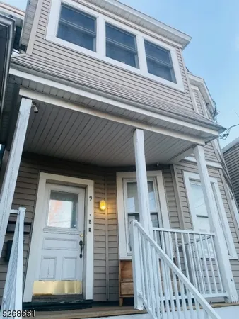a view of a house with wooden deck front door