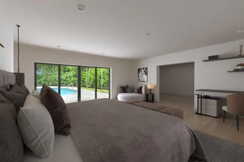 a bed room with two bed and a large window