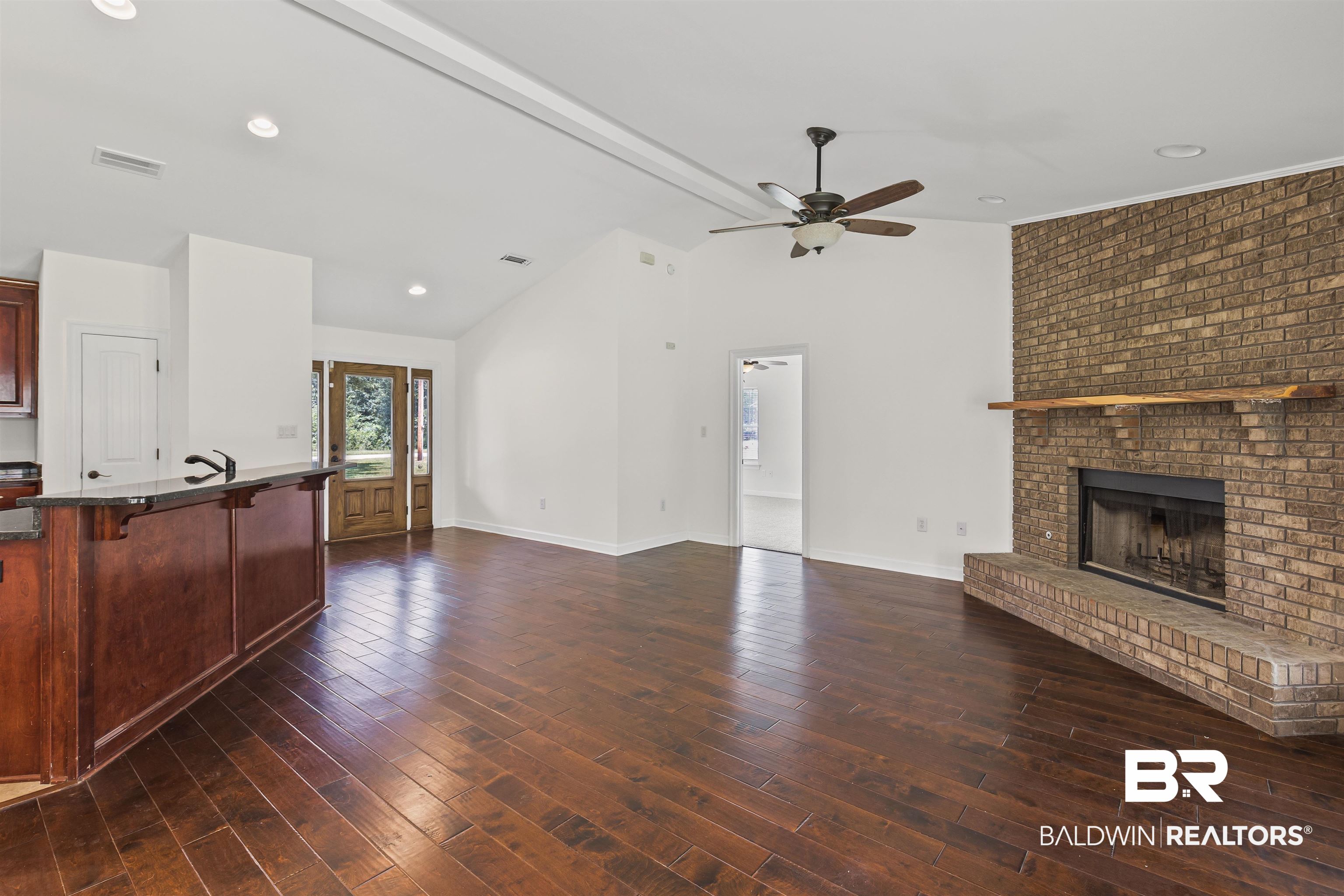 924 Brady Road North Bay Minette, AL 36507 - Photo 9 of 26 Unfurnished living room with a brick fireplace, recessed lighting, and dark wood-type flooring