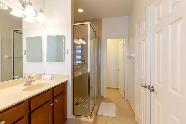 a bathroom with a sink a mirror and a shower