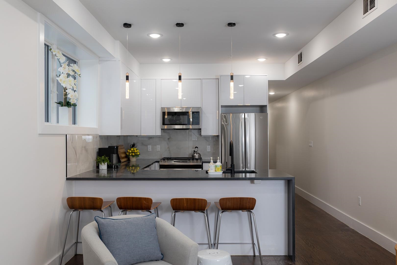 39 Boyd Avenue Jersey City, NJ 07304 - Photo 1 of 29 a kitchen with stainless steel appliances granite countertop a refrigerator and a sink